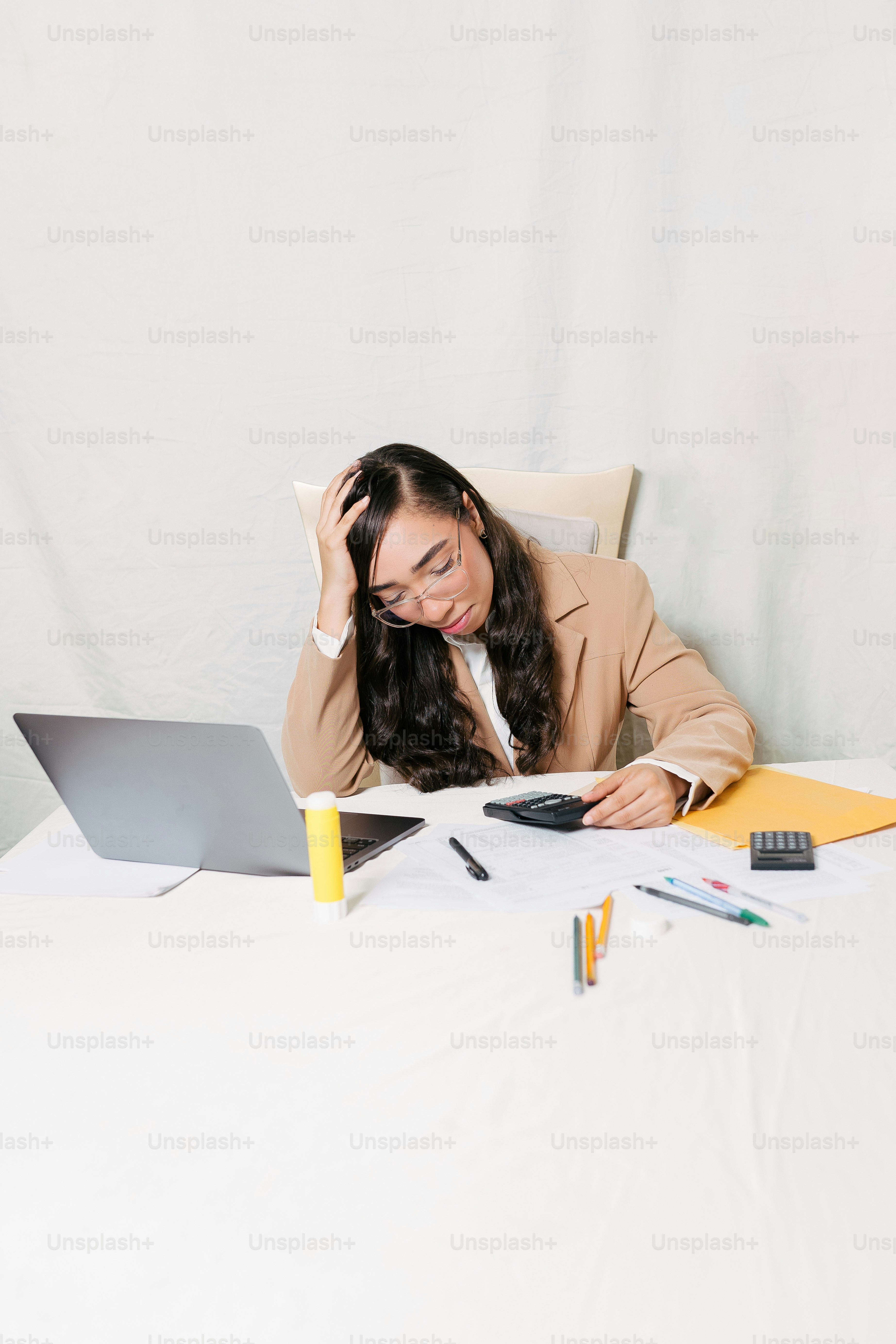 a woman sitting in front of a laptop computer