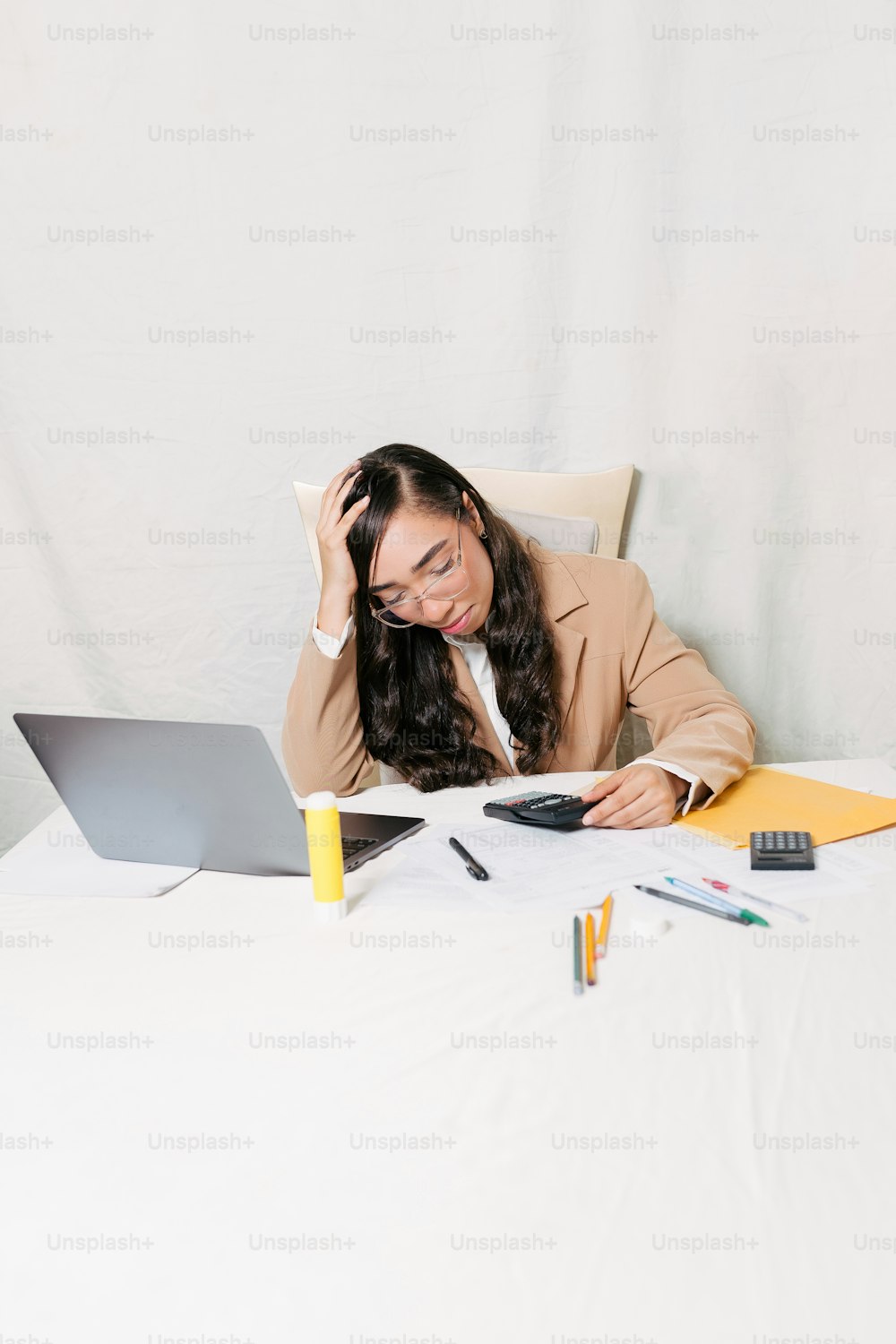 a woman sitting in front of a laptop computer