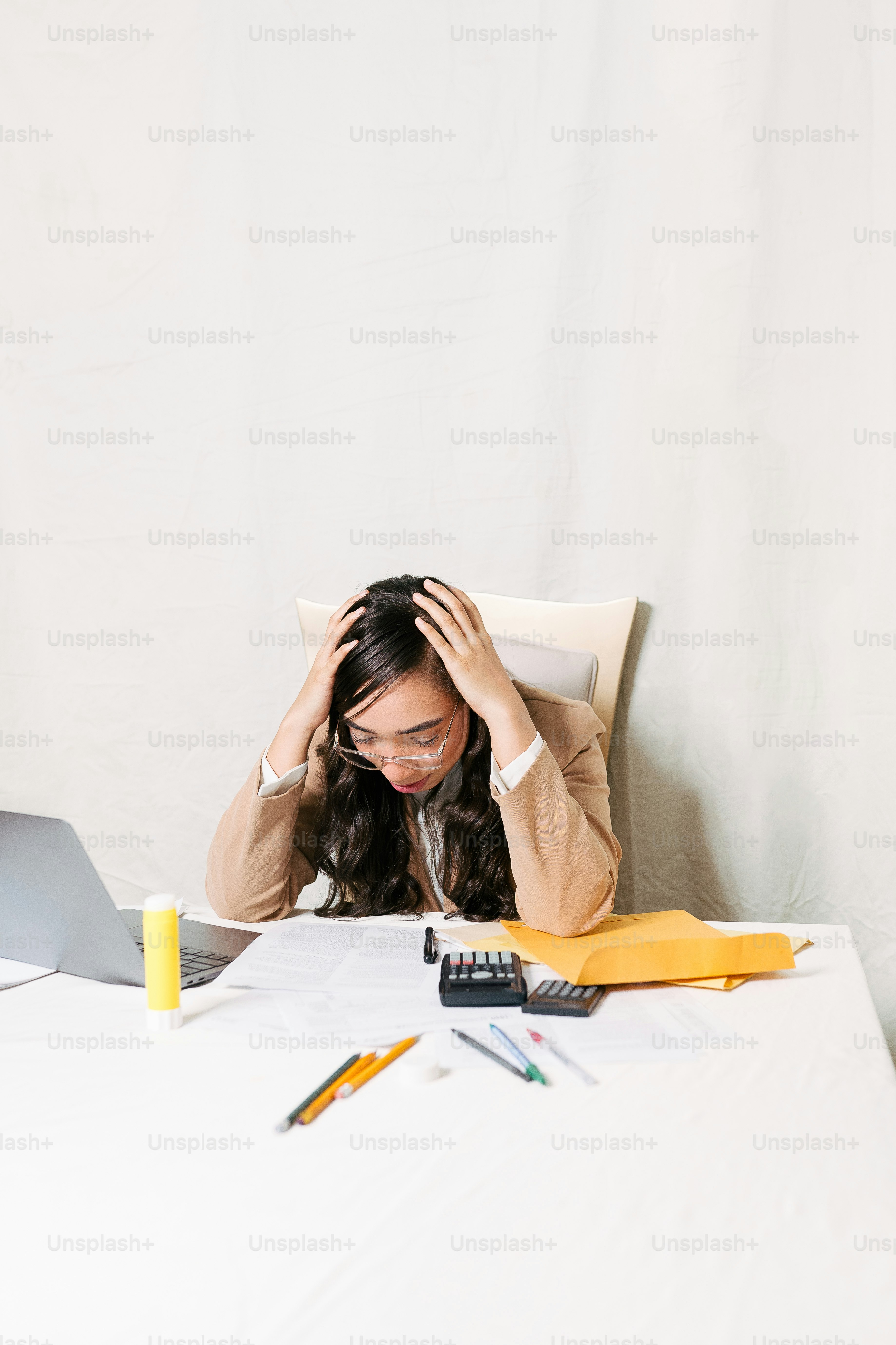 a woman sitting at a table with a laptop