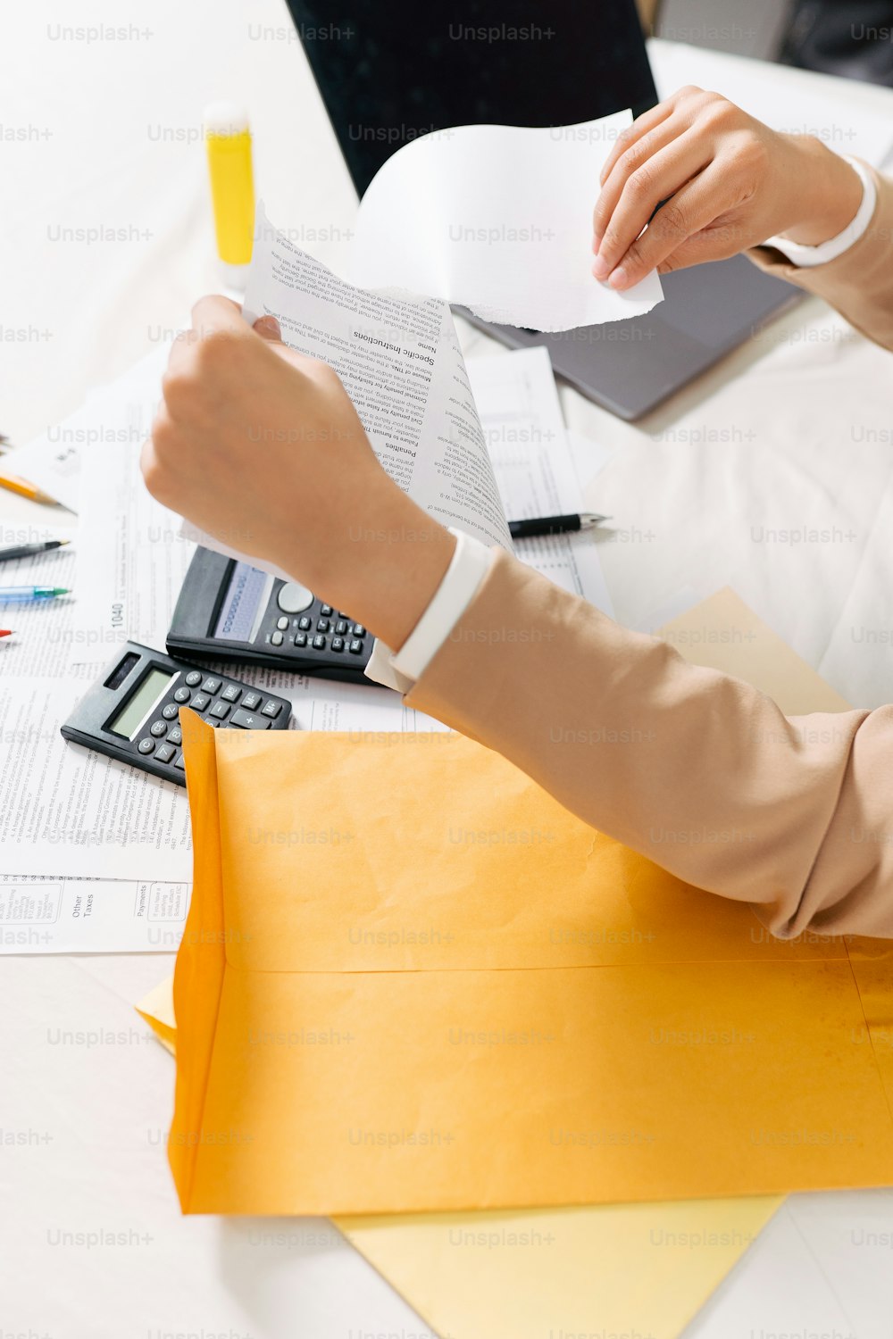 a person sitting at a desk with a calculator and a calculator