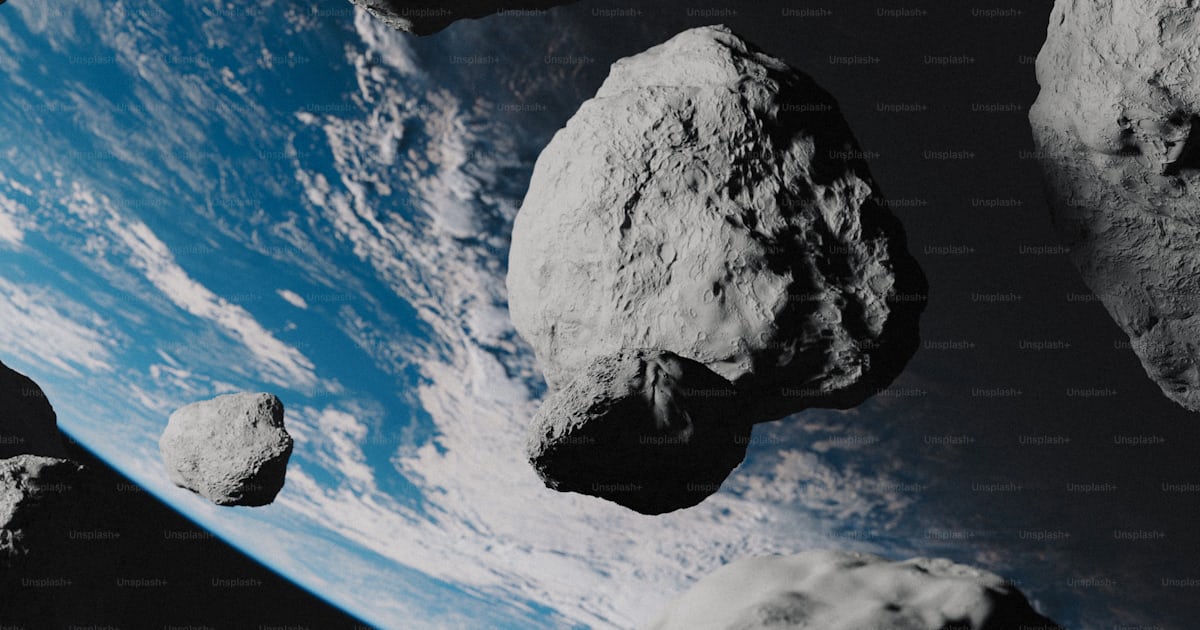 A group of rocks flying through the air photo – Outer space Image on ...