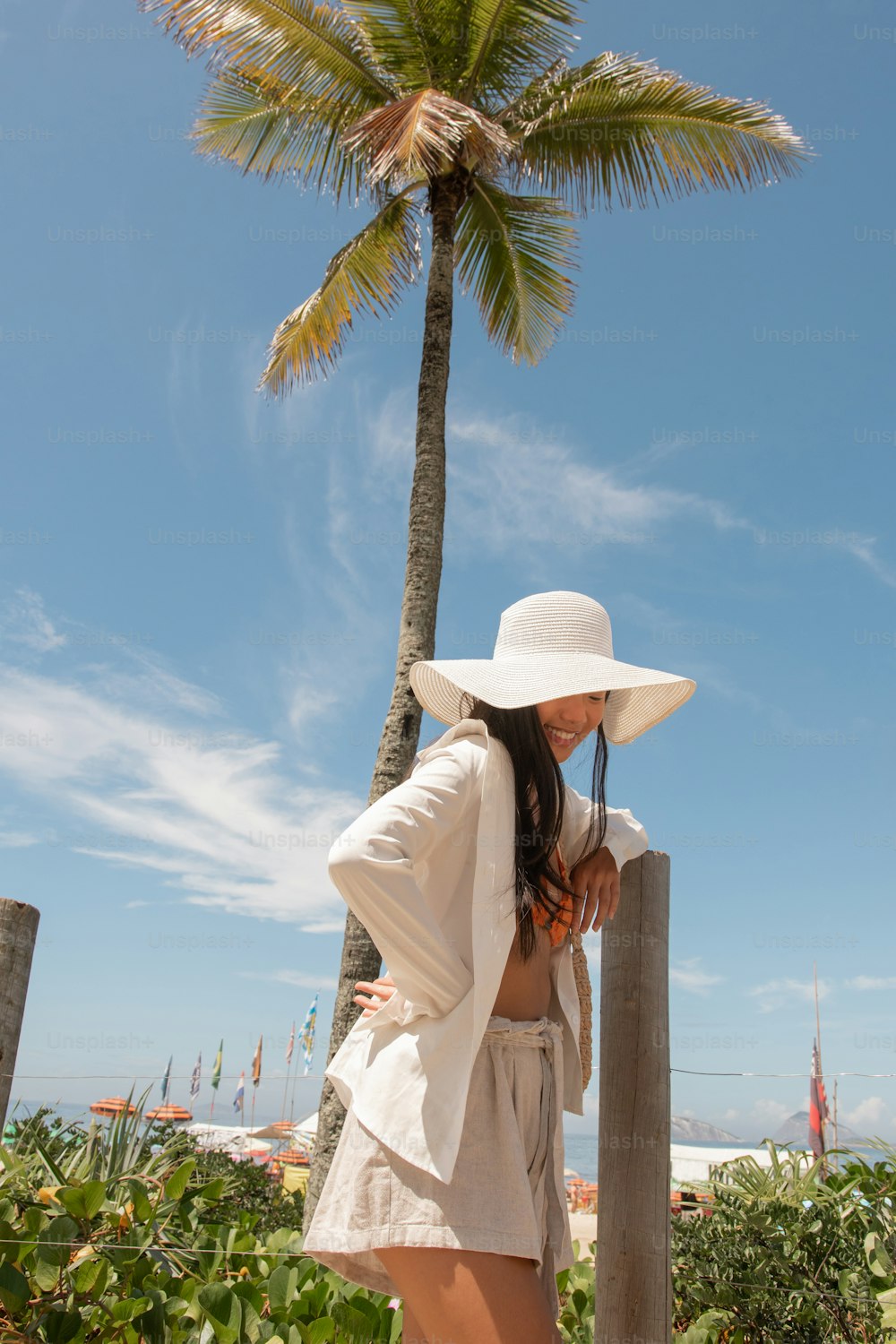 a woman wearing a white hat and a white dress