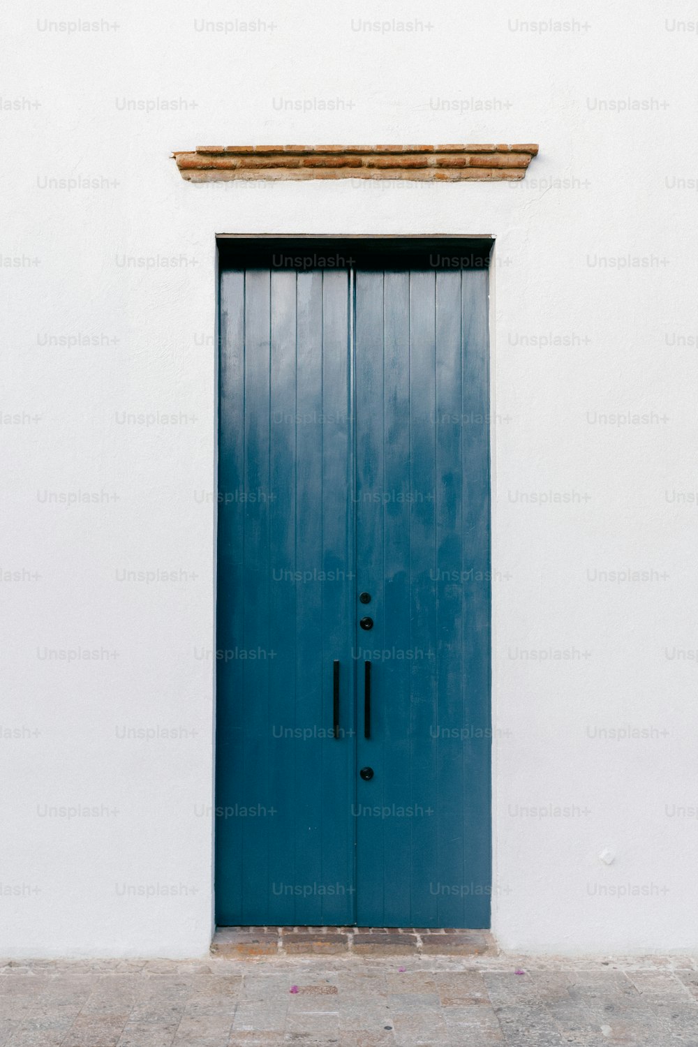 a white building with a blue door and window