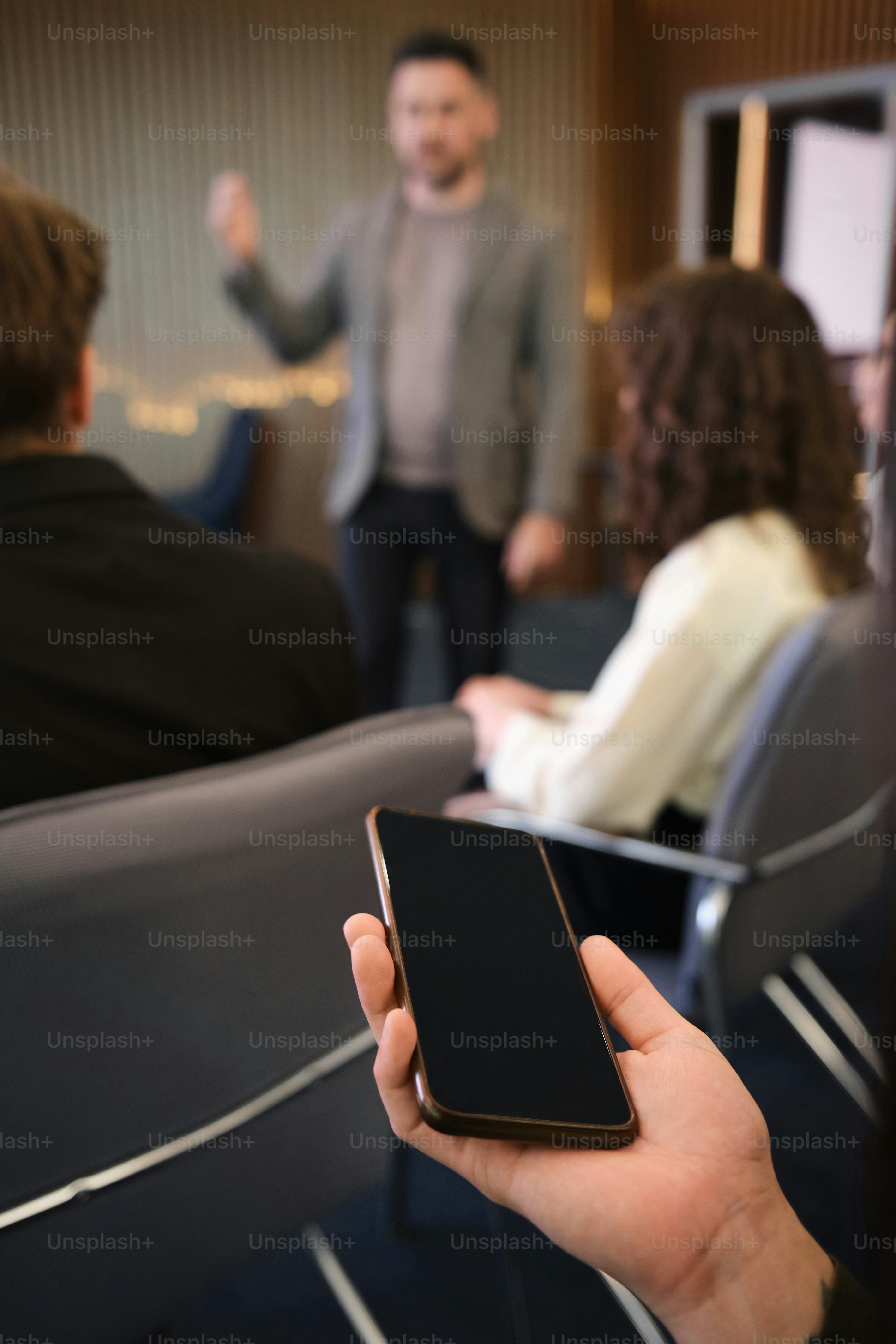 a person holding a cell phone in their hand