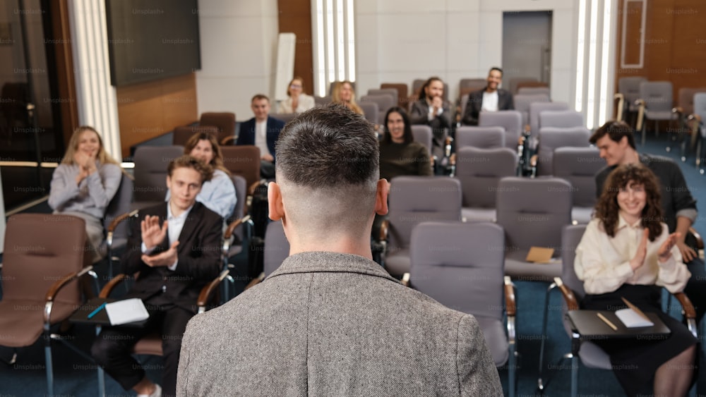 a man standing in front of a room full of people