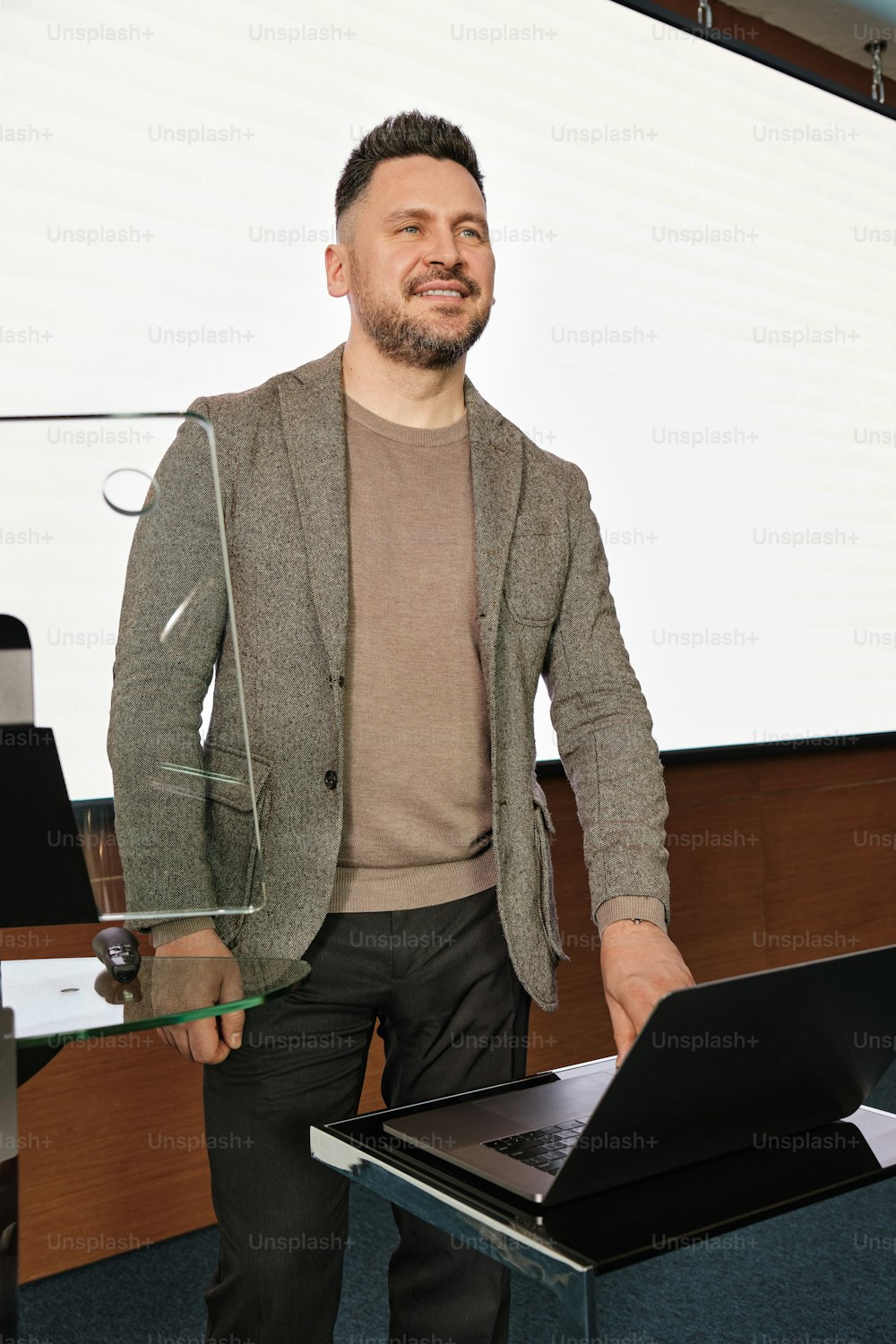 a man standing in front of a laptop computer