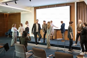 a group of people standing in front of a projector screen