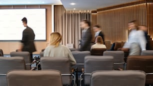 a group of people standing around a conference room