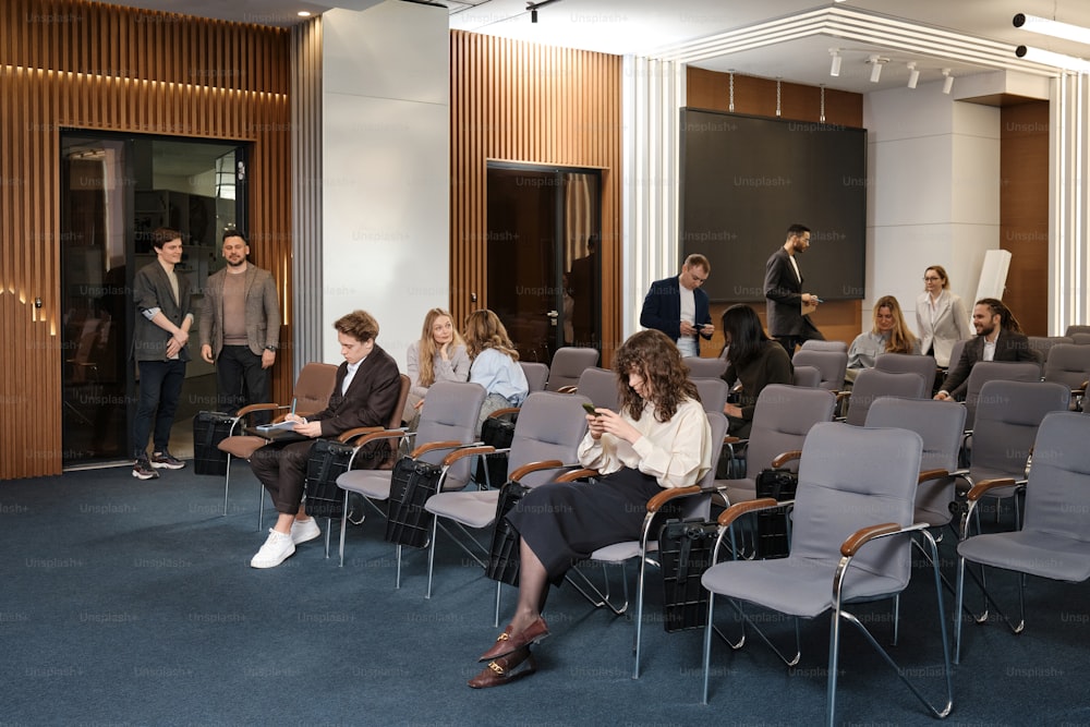 a group of people sitting in chairs in a room