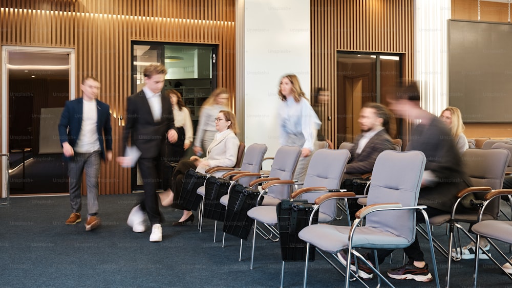 a group of people standing around a conference room