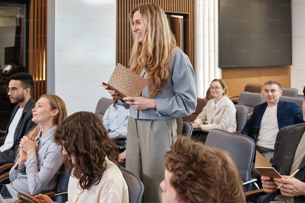 a woman standing in front of a group of people