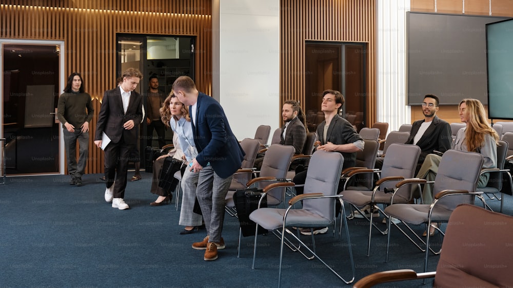 a group of people in a room with chairs