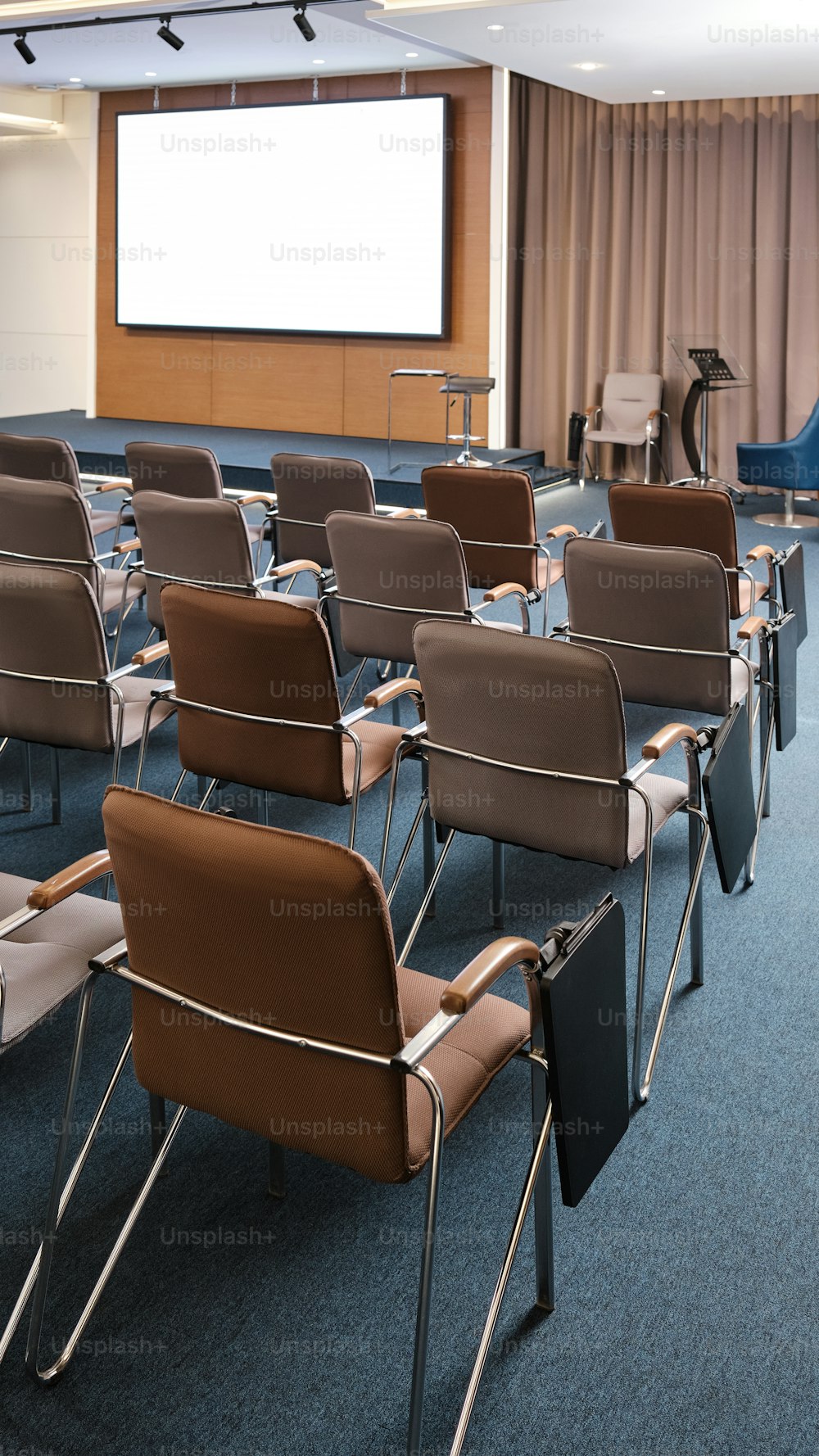 a room filled with chairs and a projector screen