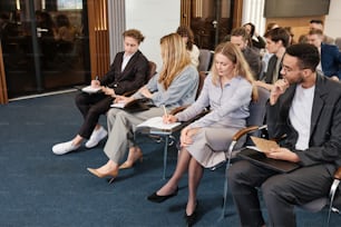 a group of people sitting next to each other