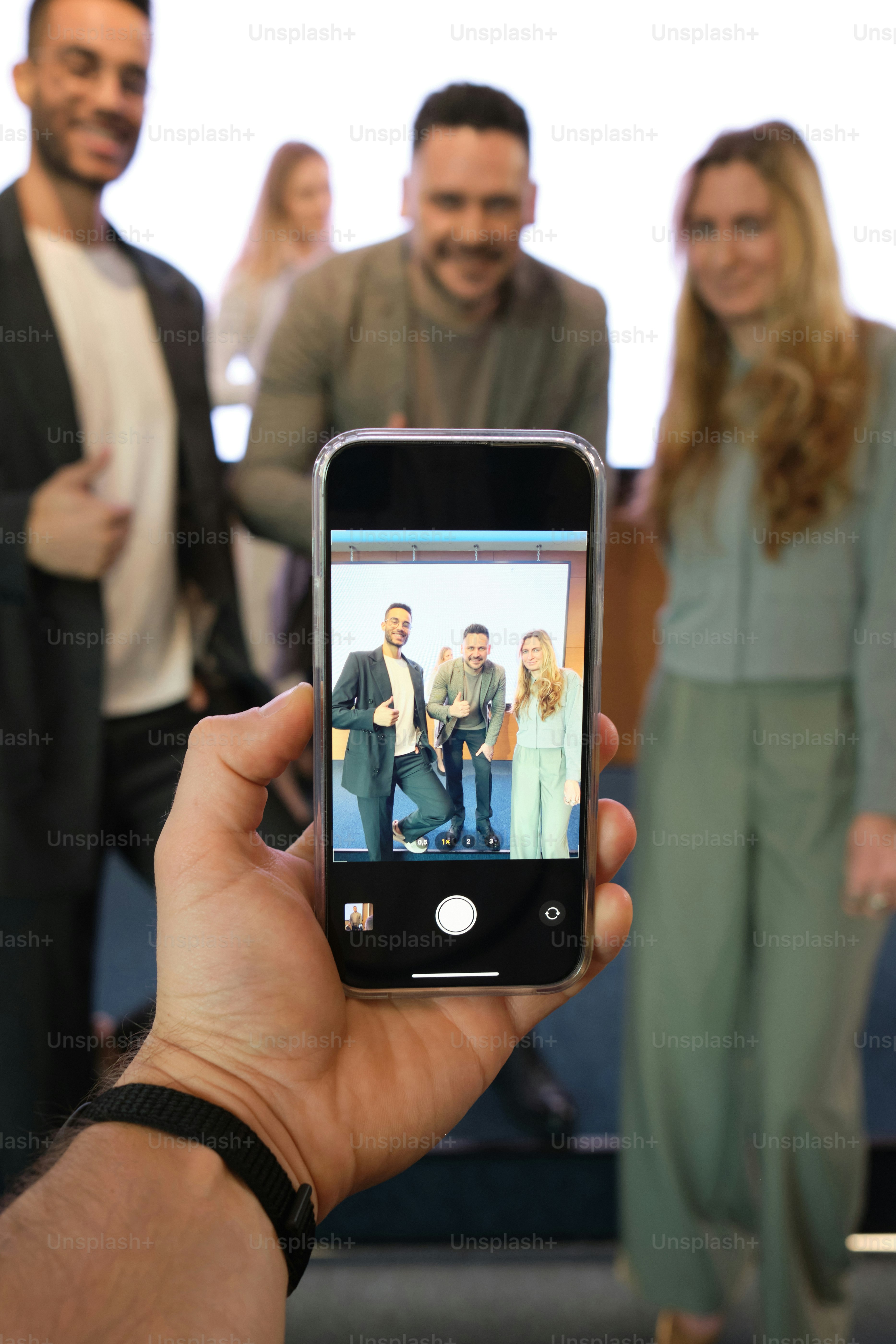 cell phone screen POV where students take pictures with the lecturer
