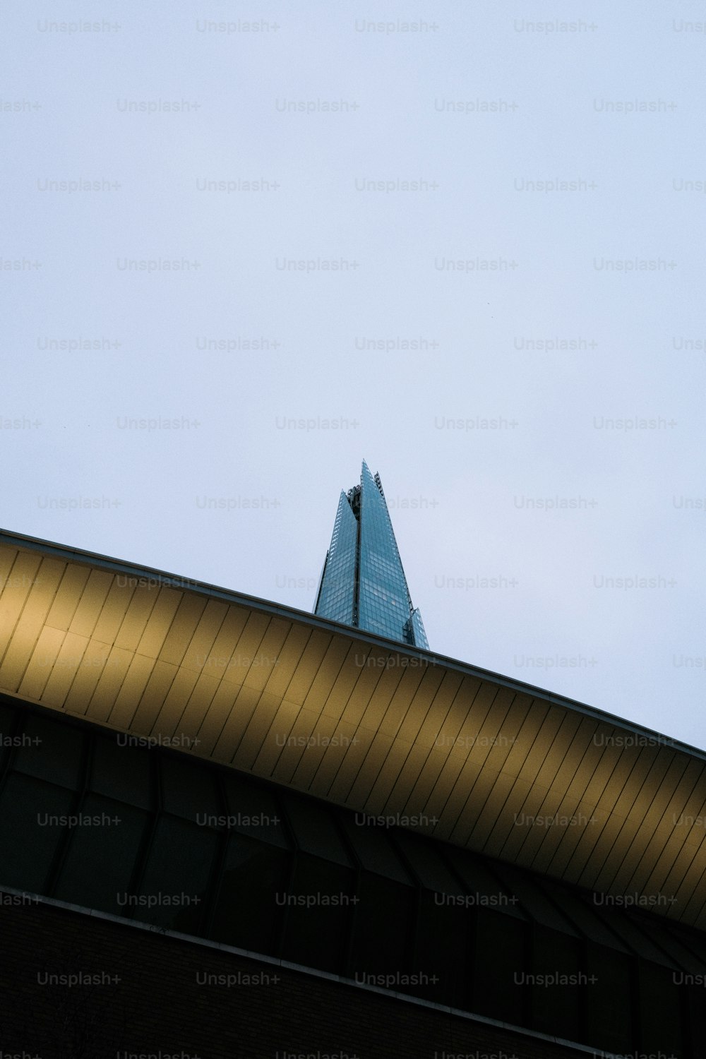 a building with a triangular roof and a sky background