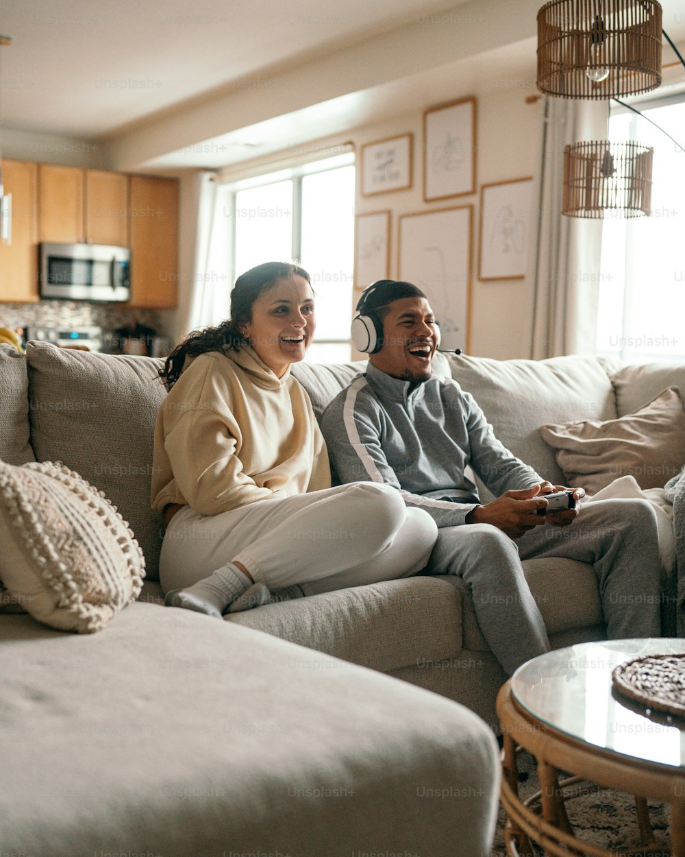 um homem e uma mulher sentados em um sofá jogando um videogame