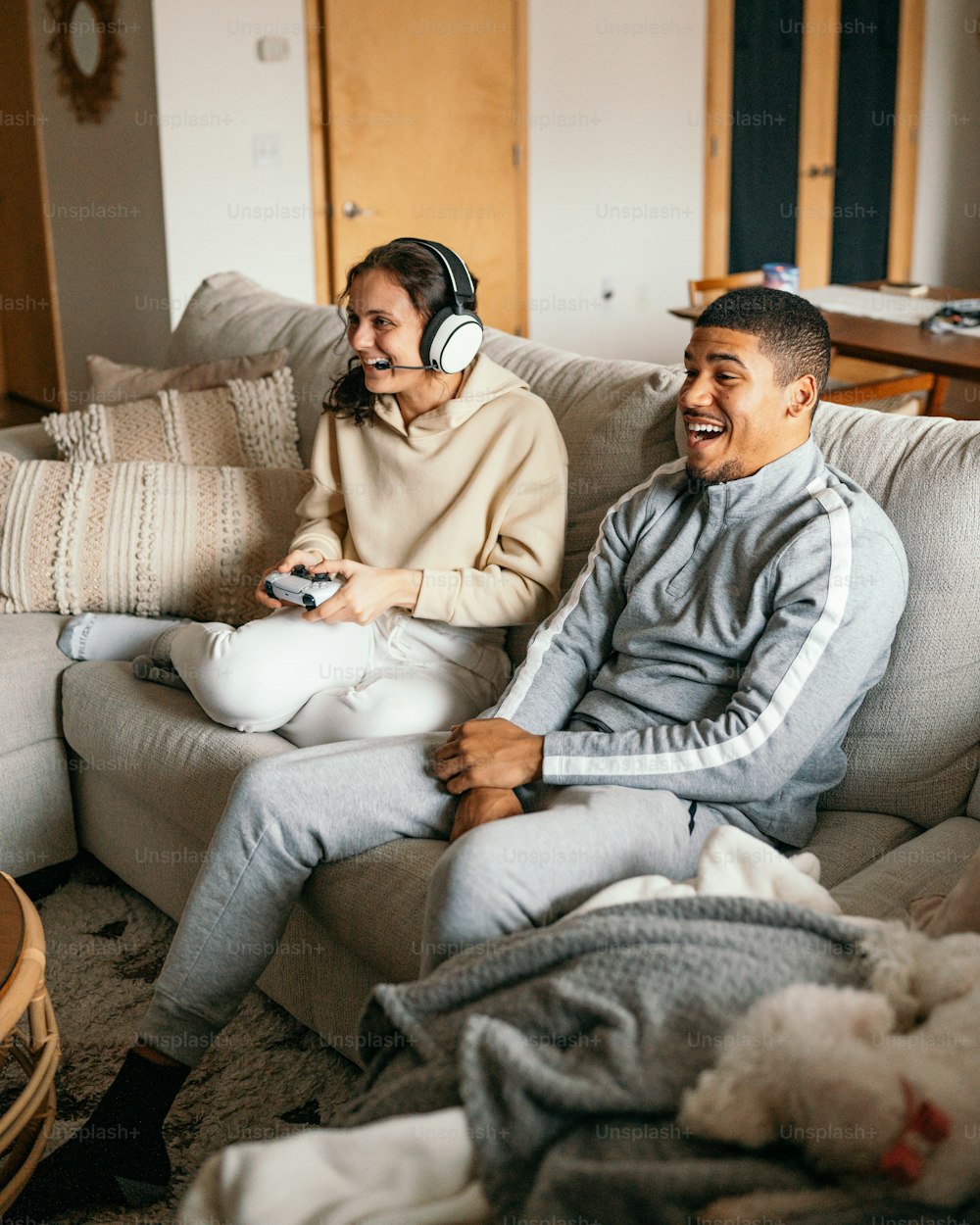 a couple of people sitting on top of a couch