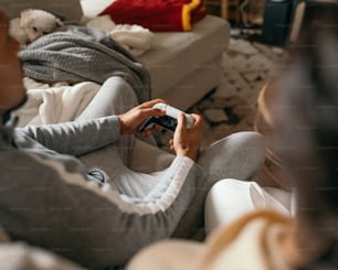 a woman sitting on a couch playing a video game