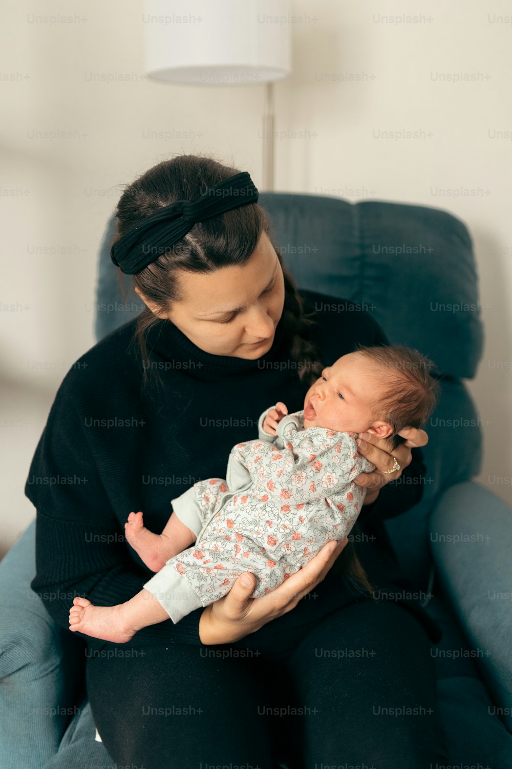 a woman holding a baby in her arms