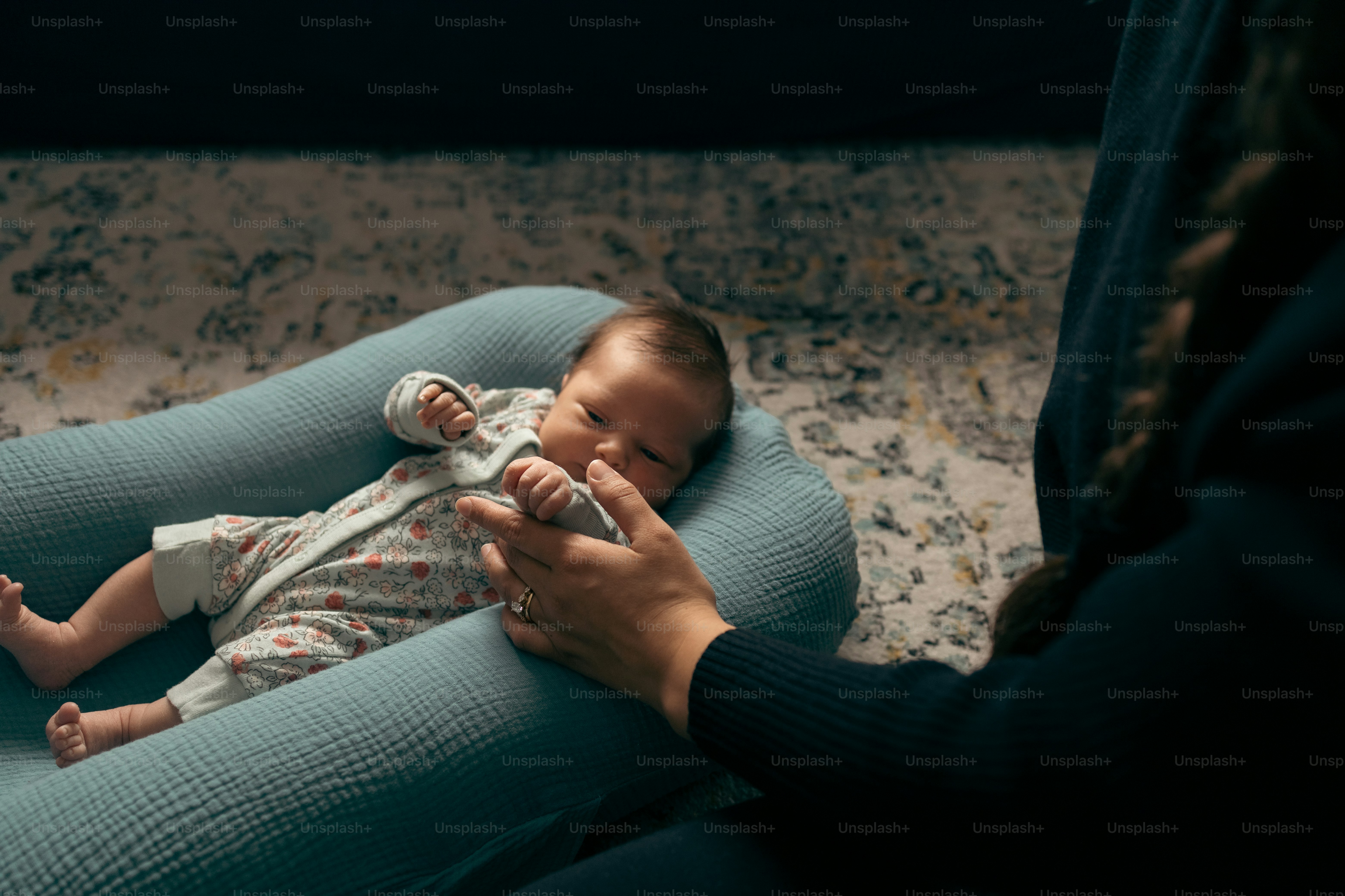 a woman holding a baby in her arms