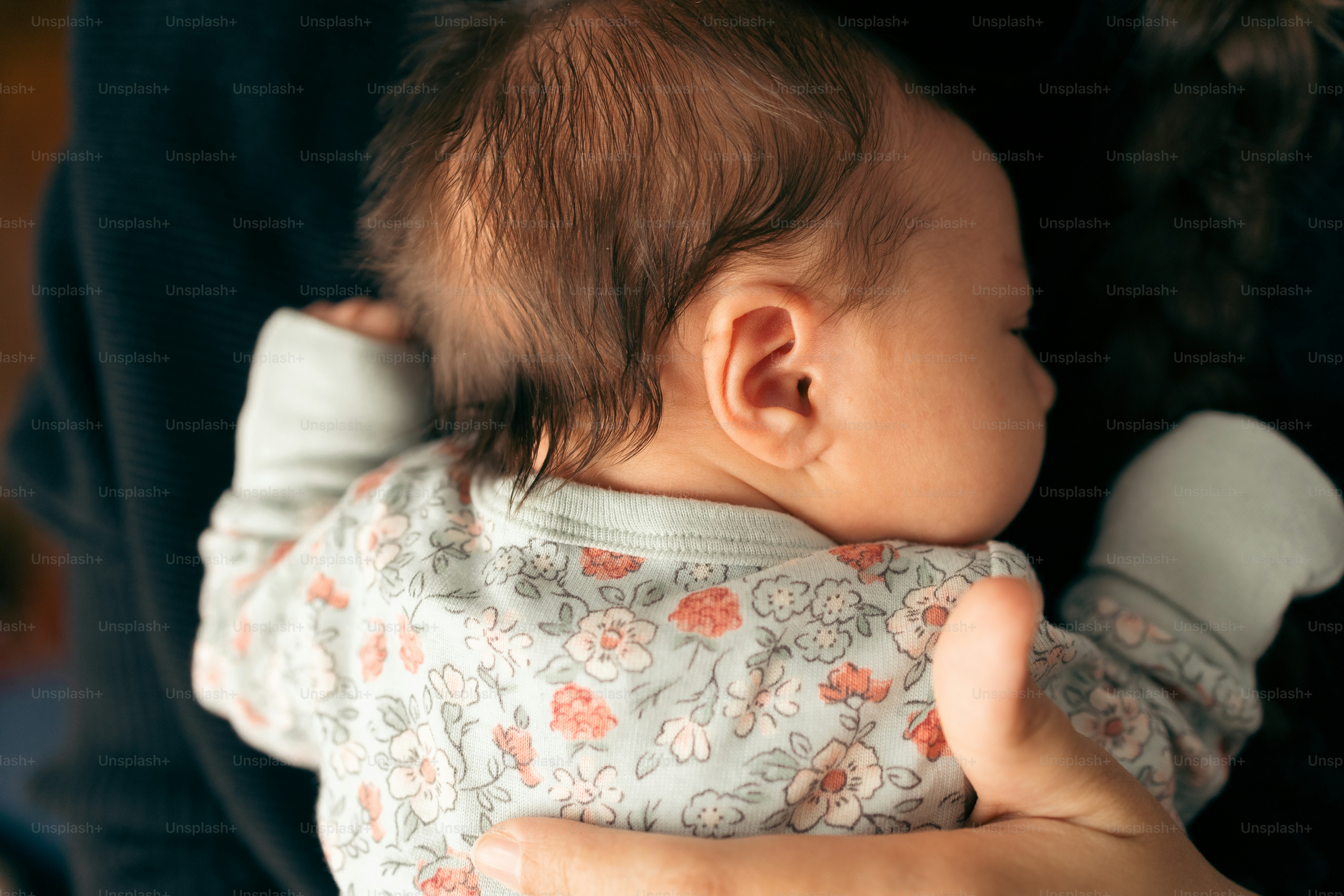 a woman holding a baby in her arms