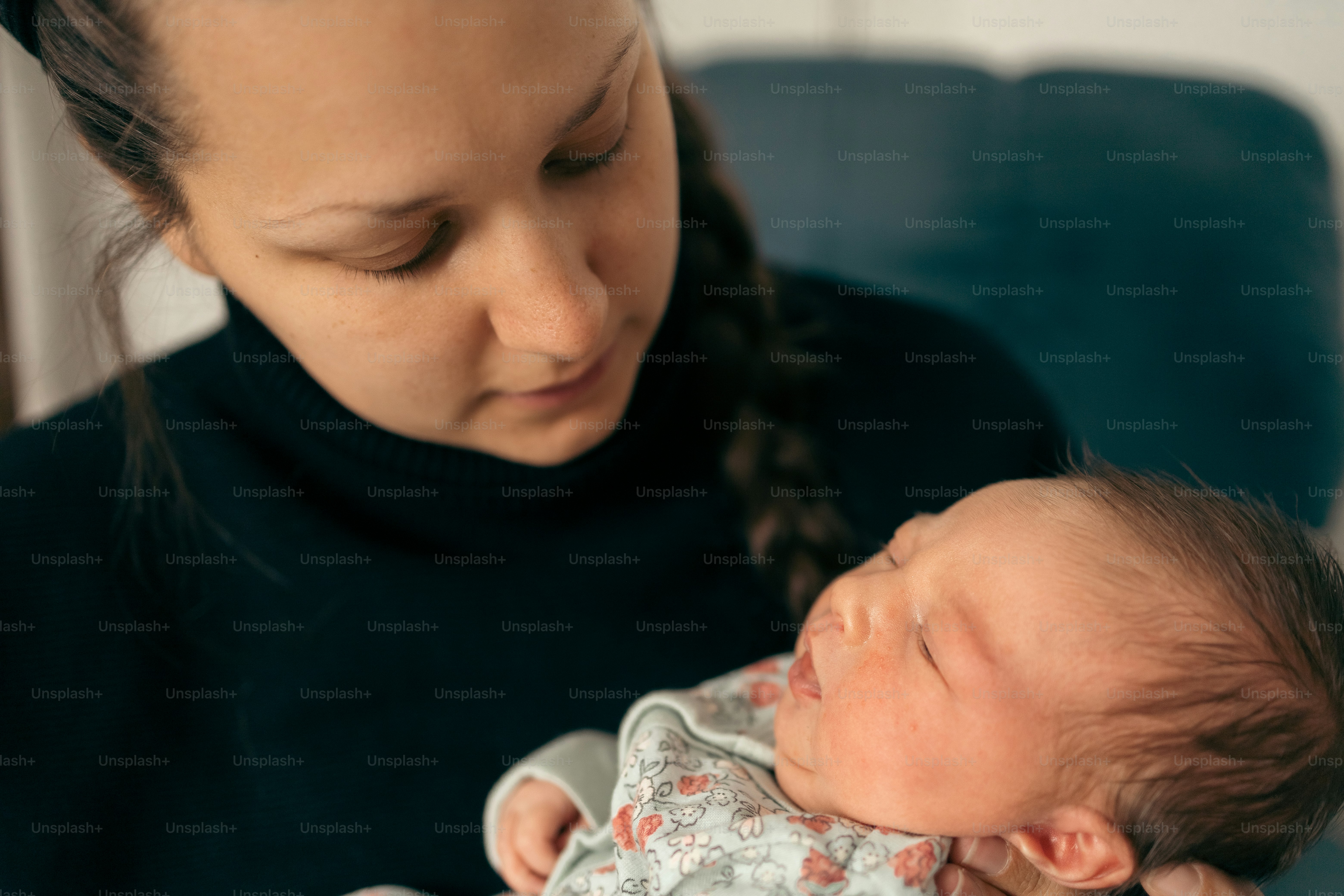 a woman holding a baby in her arms