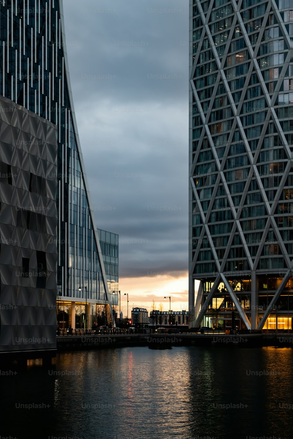 a couple of tall buildings next to a body of water