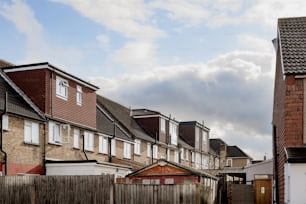 a row of houses with a cloudy sky in the background