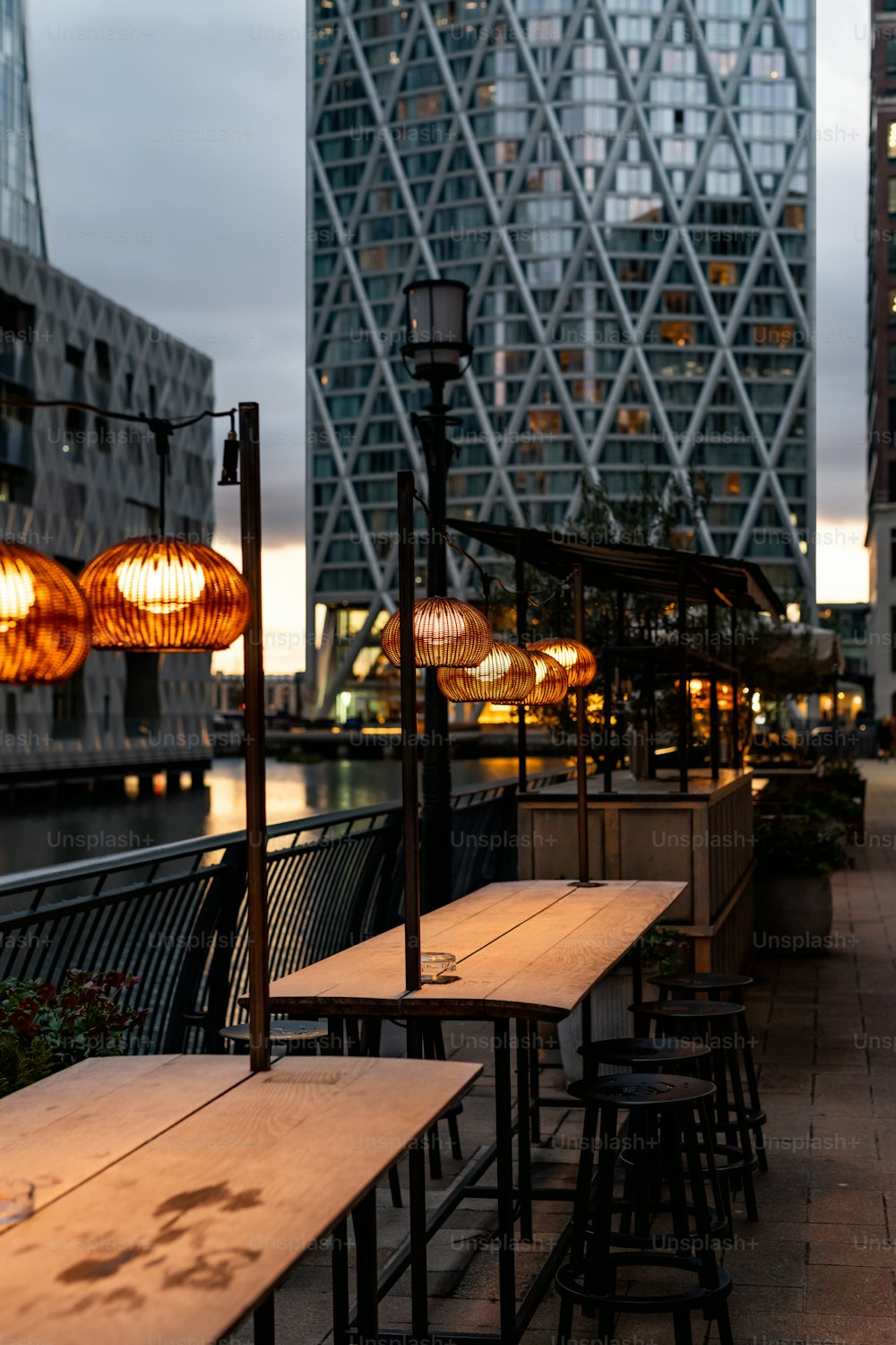 a row of wooden tables sitting next to tall buildings