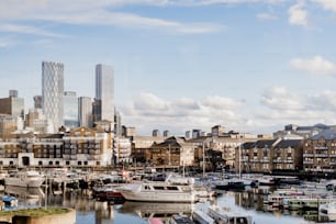 a harbor filled with lots of boats next to tall buildings