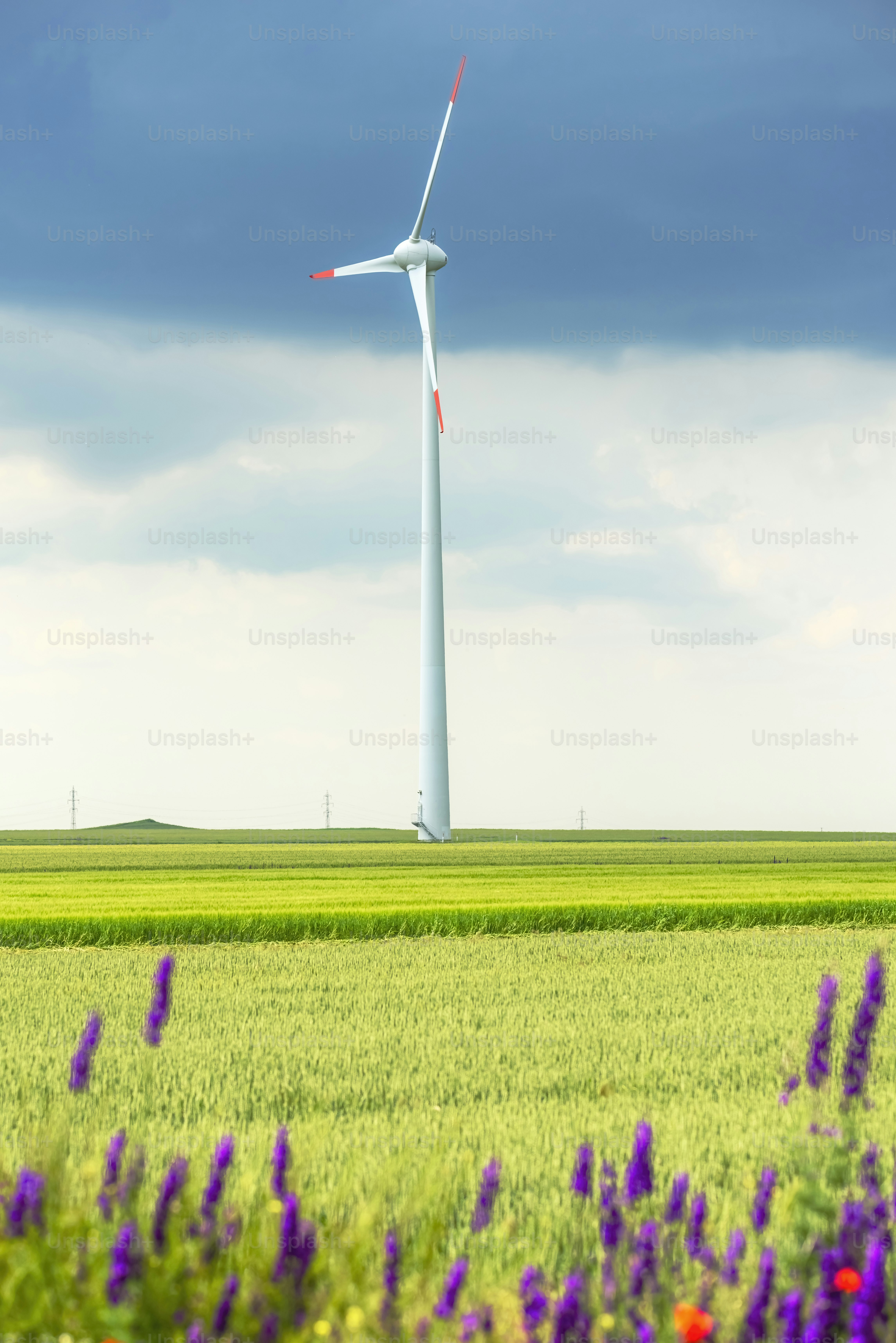 a wind turbine in the middle of a green field