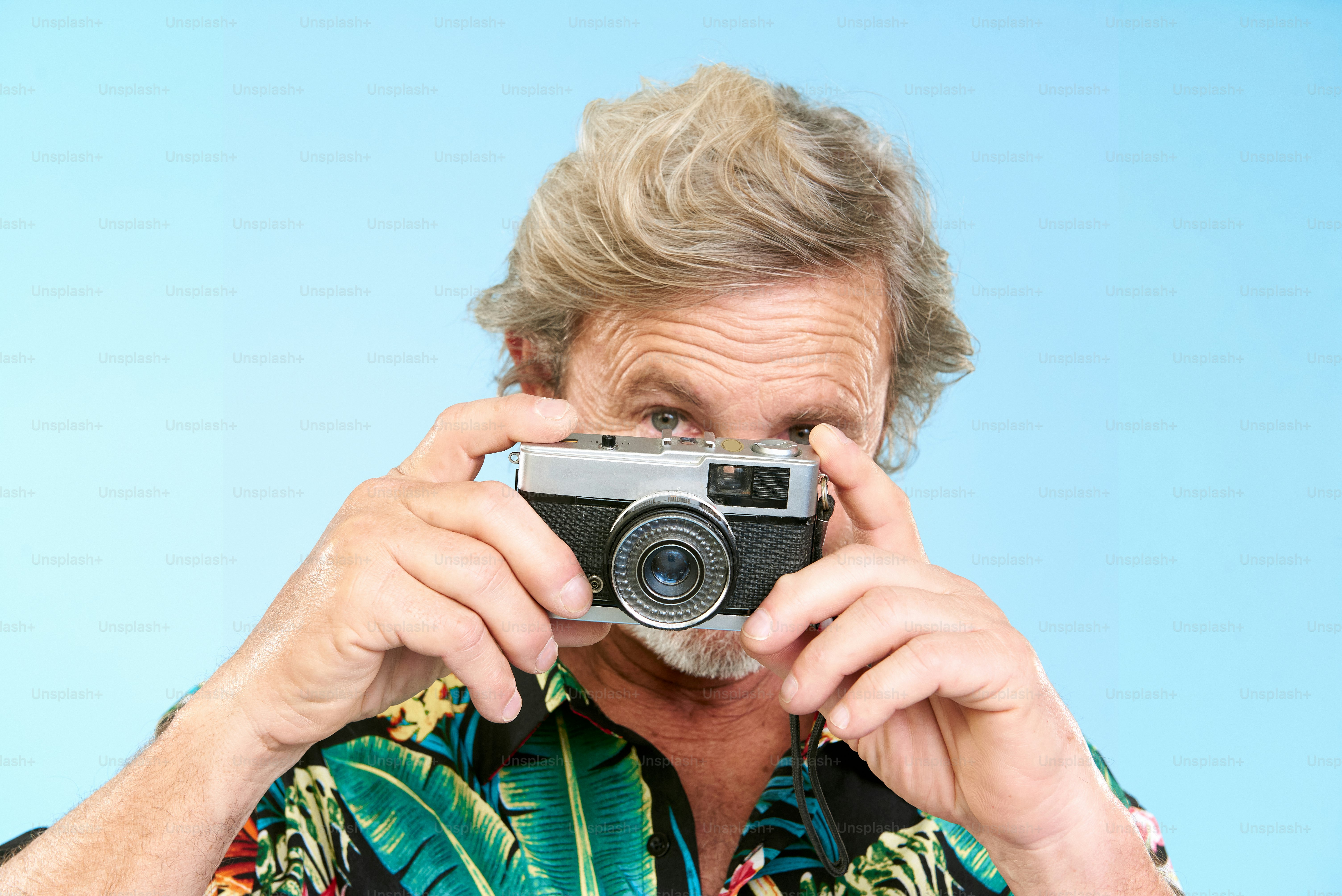 a man holding a camera up to his face