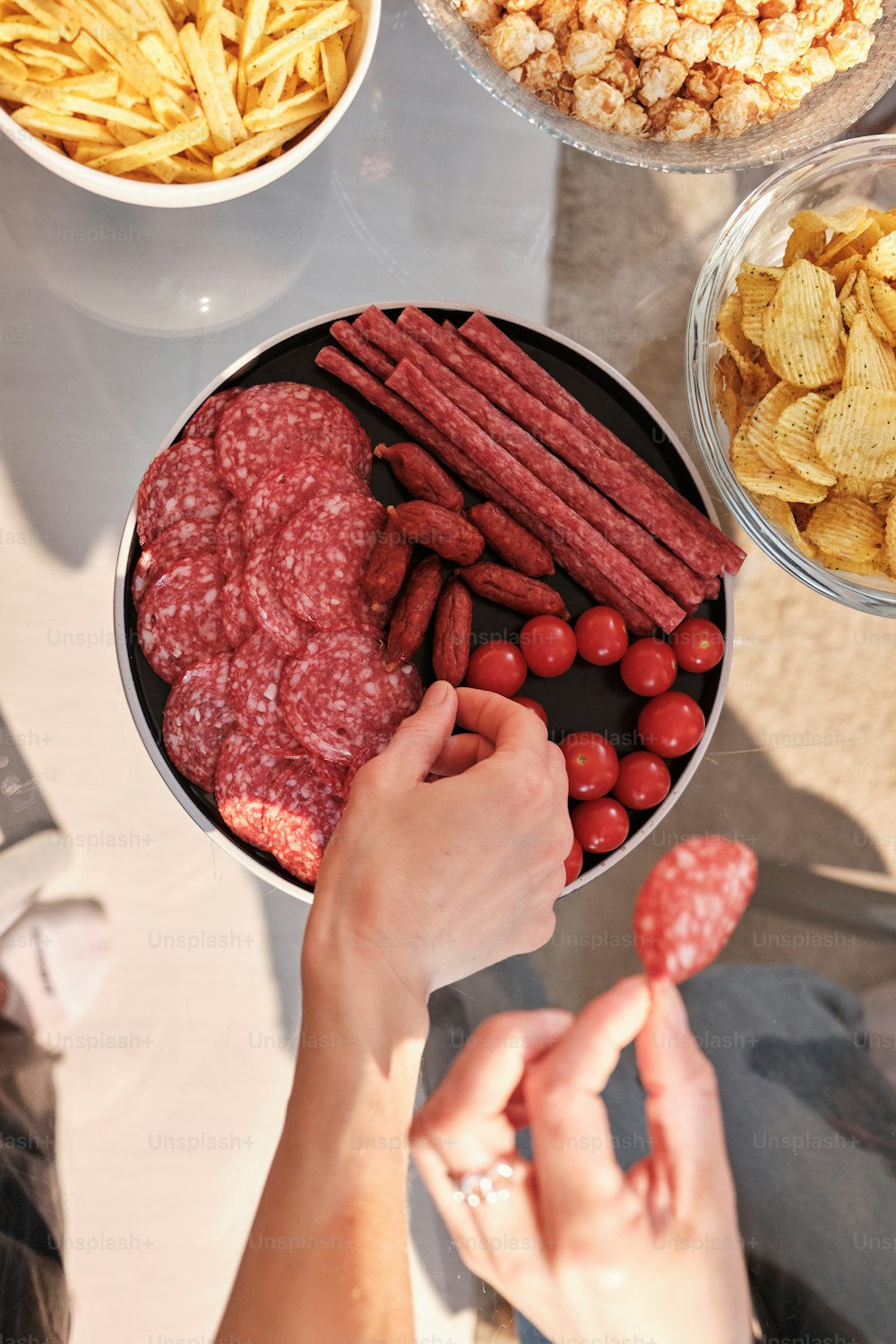 a person holding a bowl of food near other bowls of food