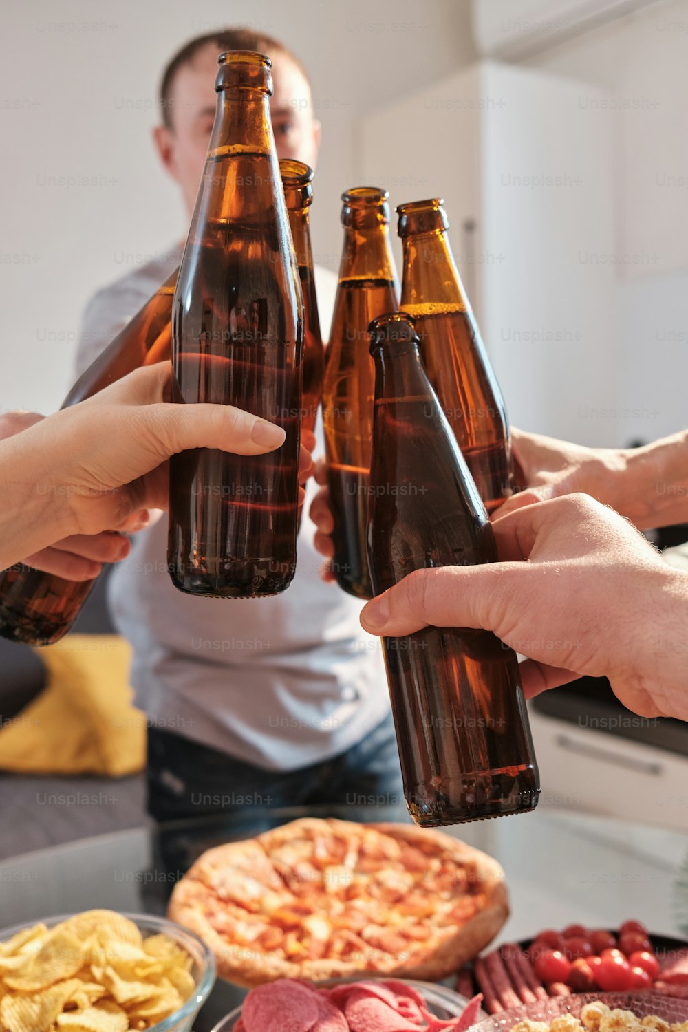 a group of people holding up beer bottles