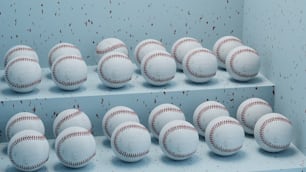 a group of baseballs sitting on top of a shelf