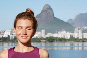 a woman standing in front of a body of water