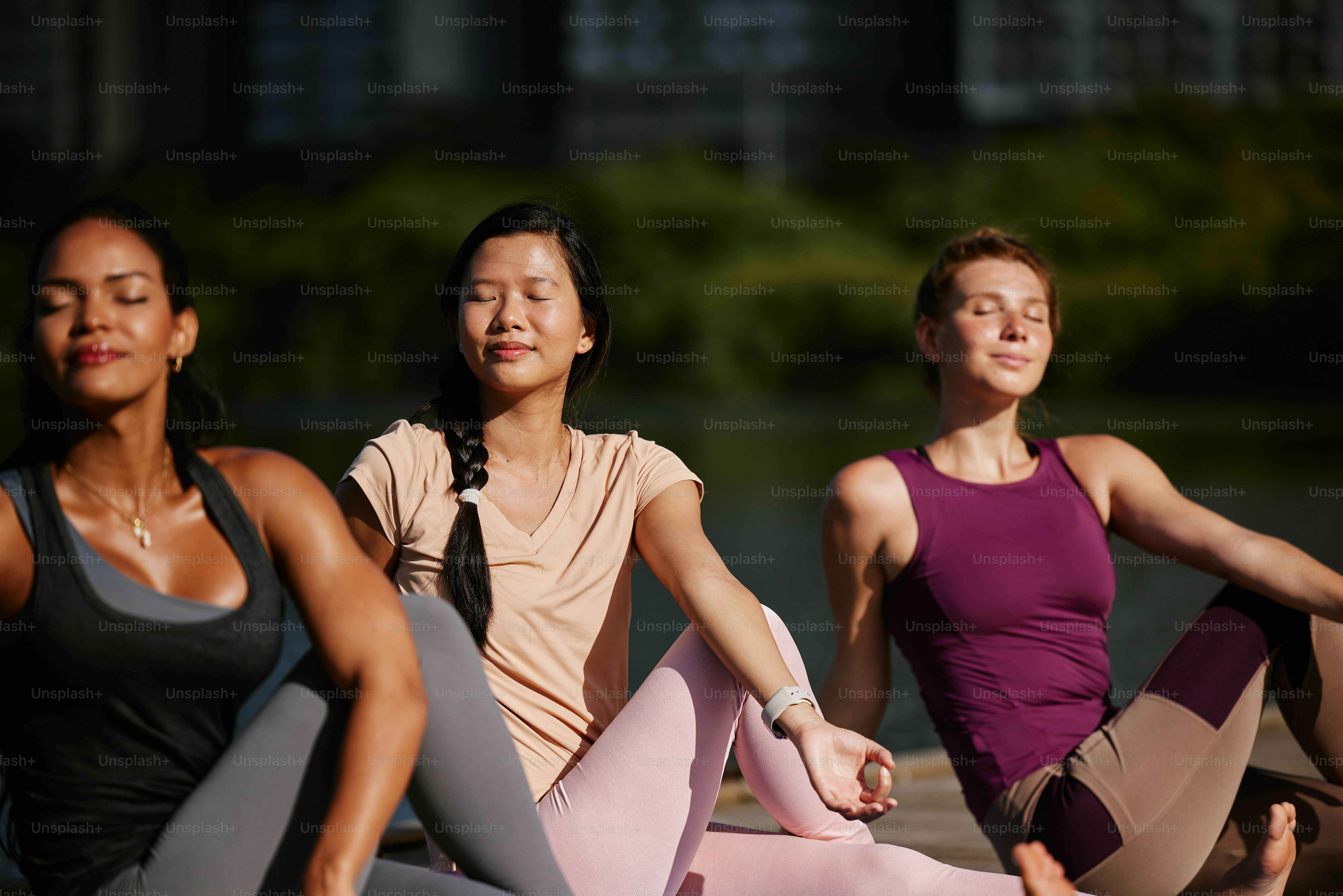 a group of people sitting on the ground doing yoga