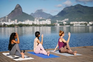 a group of women sitting on top of yoga mats