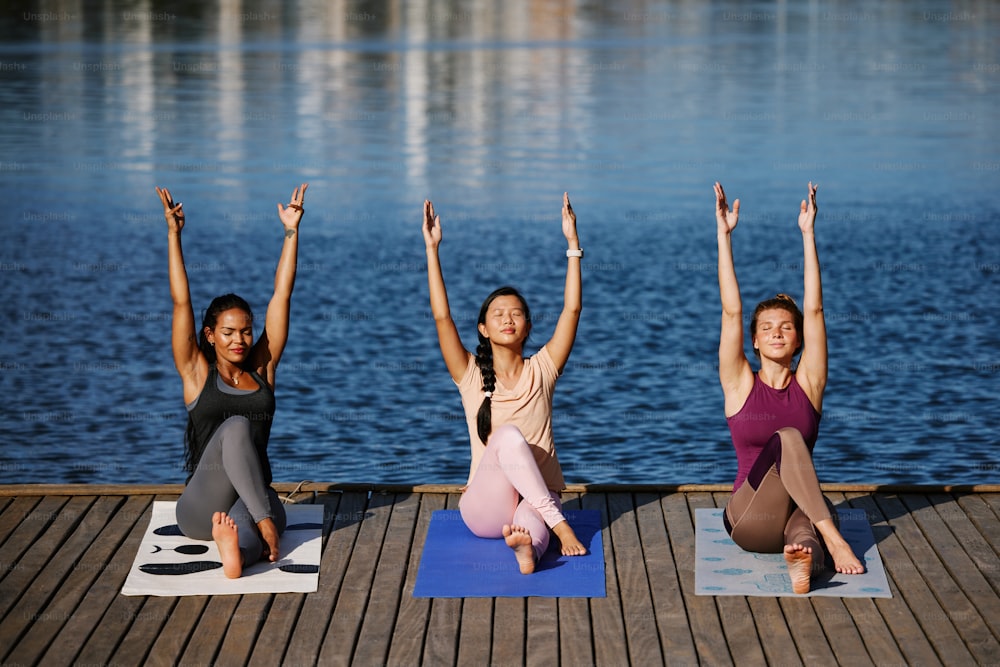 a group of women sitting on top of yoga mats