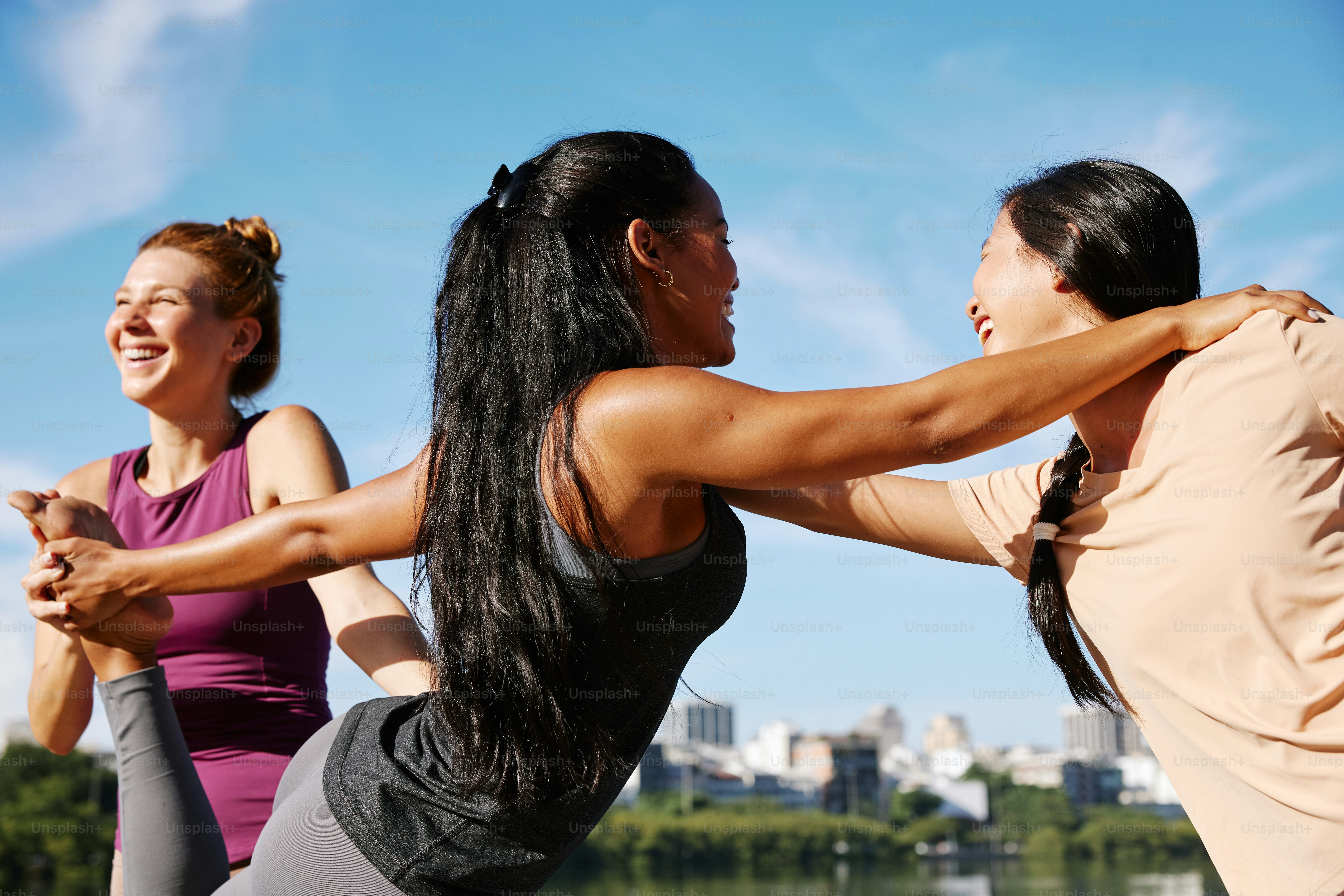 a group of women doing yoga on a sunny day