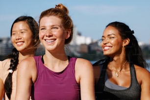 a group of three women standing next to each other