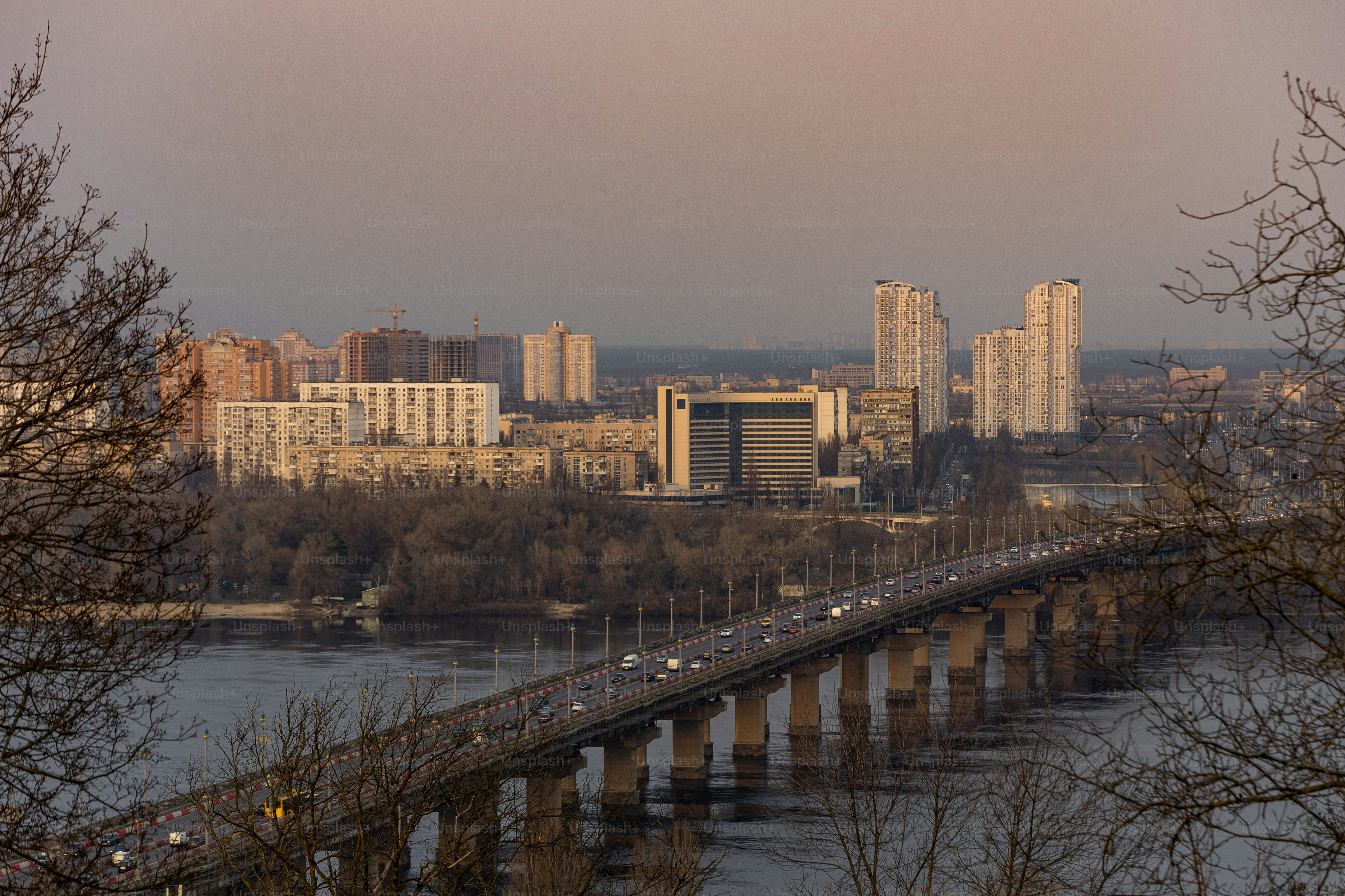 a bridge over a body of water with a city in the background
