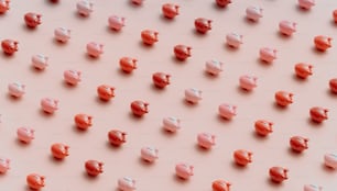 a group of small pink and red pig figurines