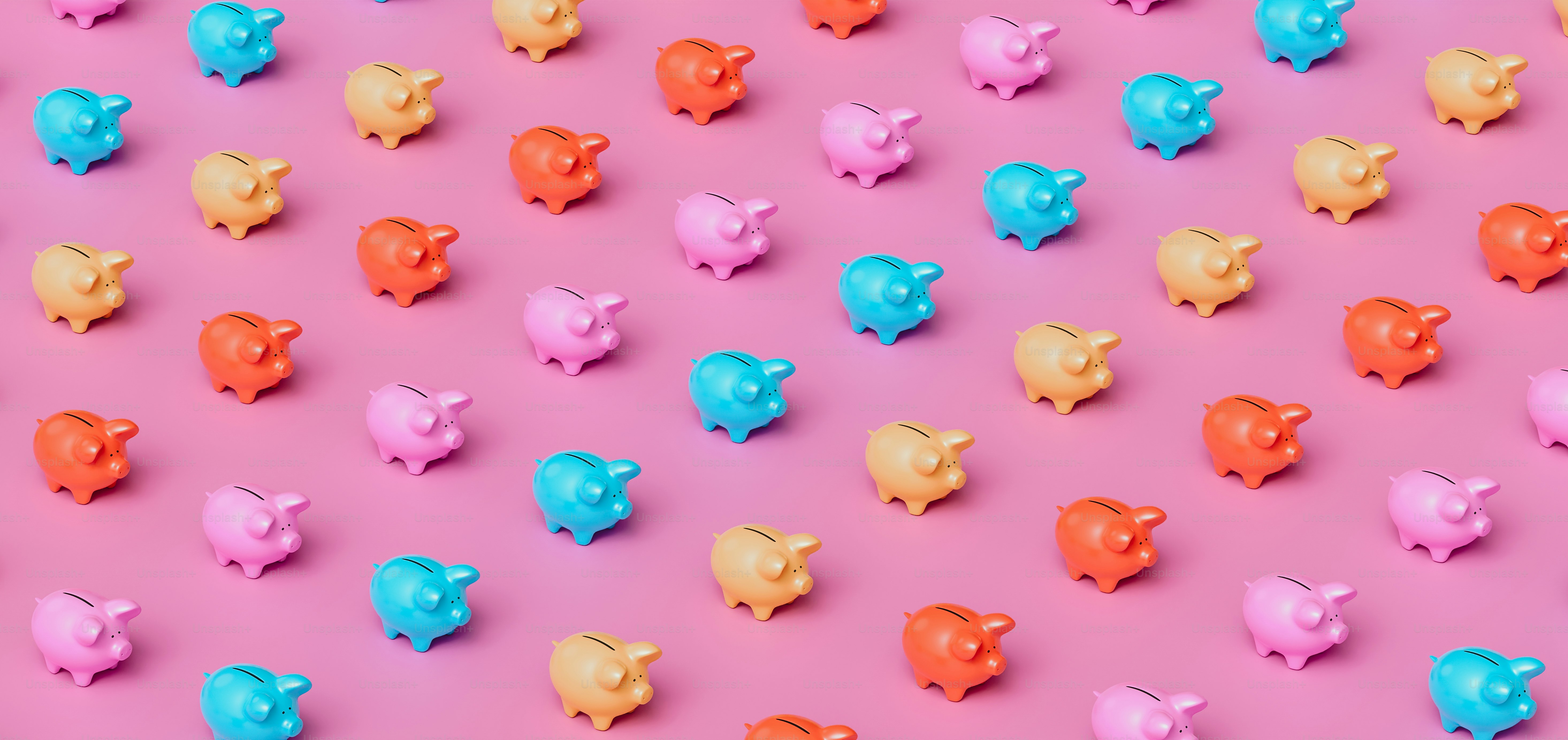 a group of colorful piggy banks on a pink background