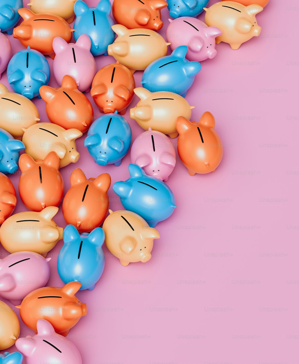 a bunch of small plastic piggy toys on a pink background