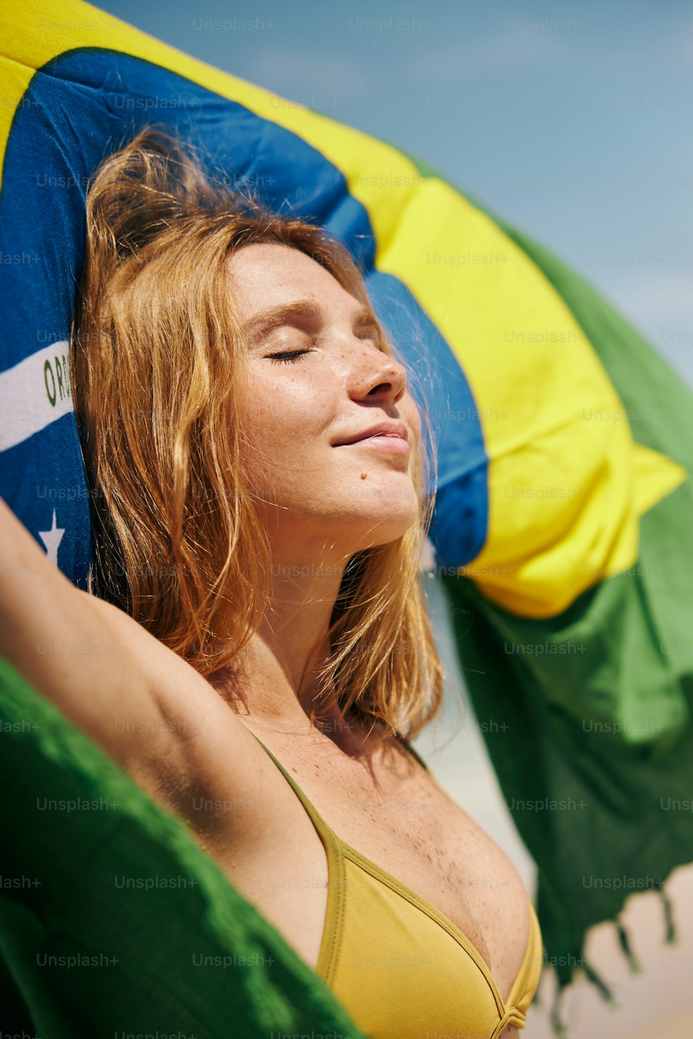 a woman in a bikini laying on a beach