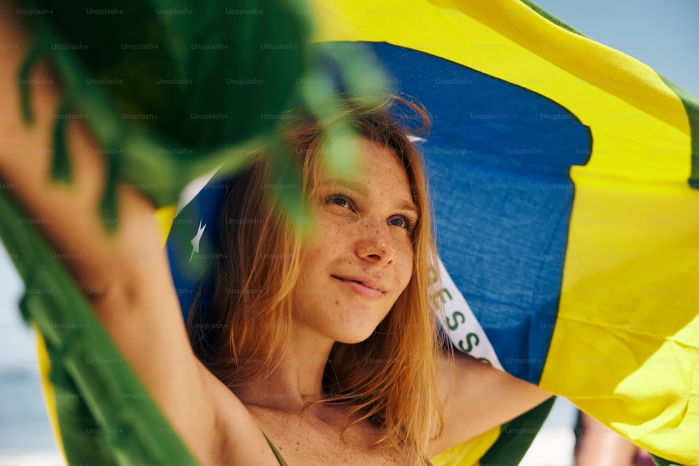 a woman holding a yellow and blue umbrella