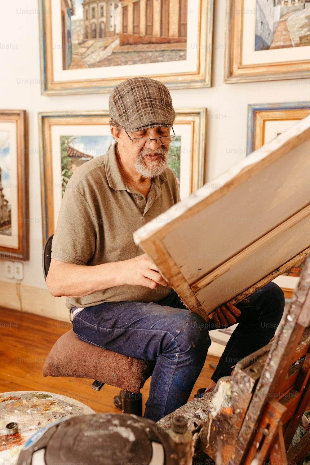 a man sitting on a chair in front of a painting