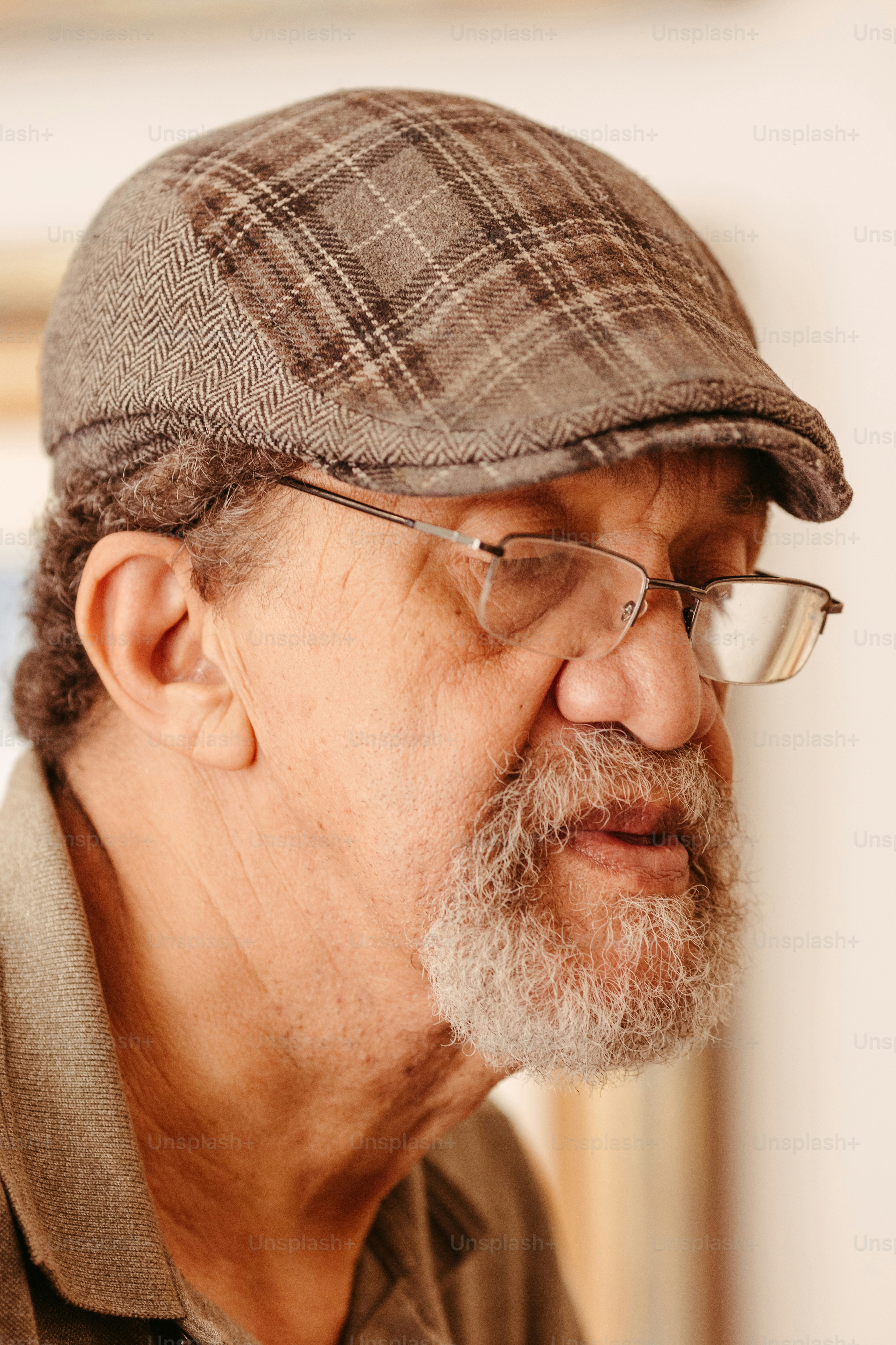 a man with glasses and a plaid hat